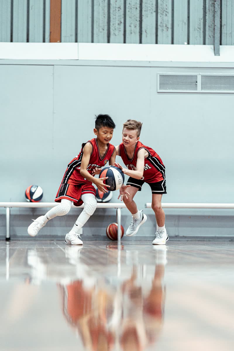 Two young players competing for a loose ball