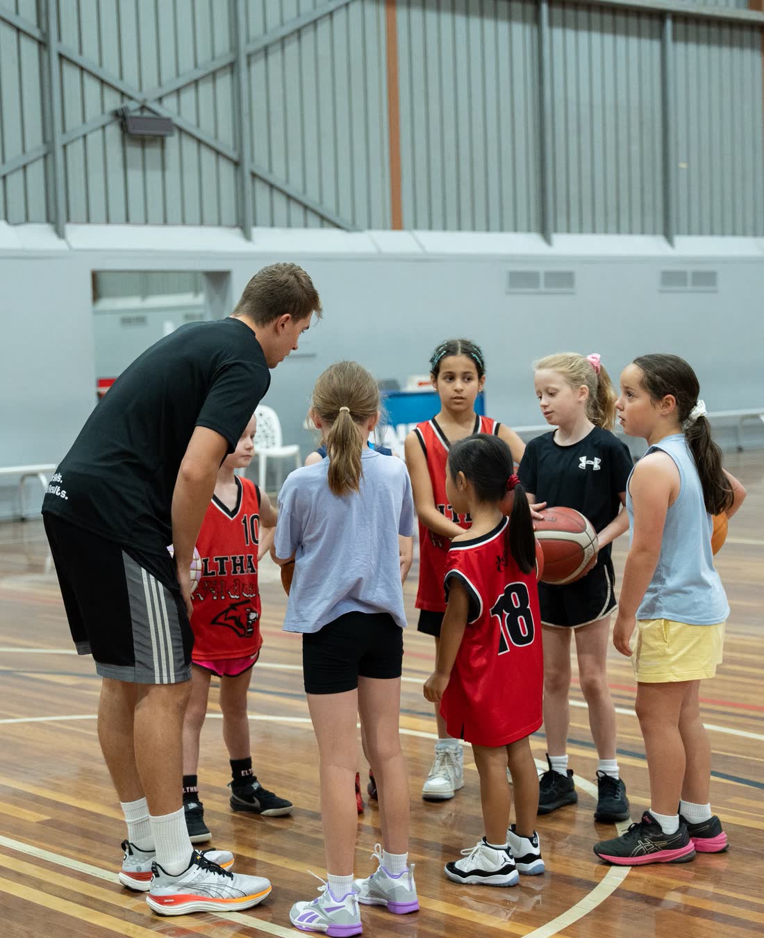 Coach running a group of players through a drill
