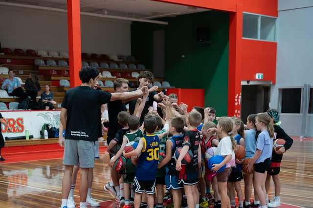 Coach briefing a group of players before a drill