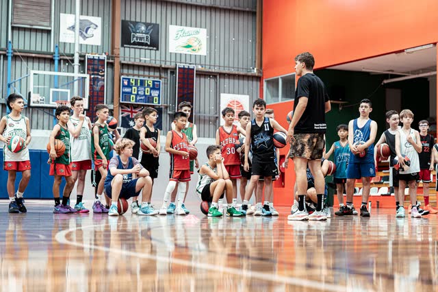 Players lined up across the court at a camp session
