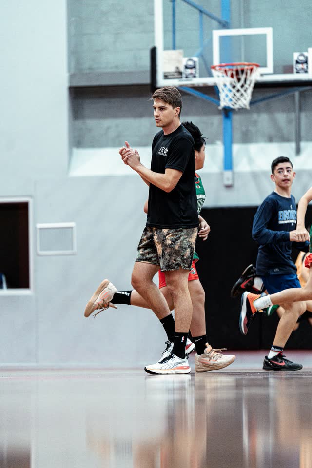 Coach demonstrating a move to players at training